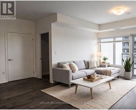 A living room with a grey couch, a wooden coffee table, and a rug.
