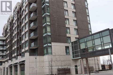 A tall building with a glass facade and a sign that reads "RE/MAX Atrium Home Realty Brokerage.".