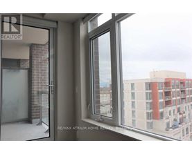 A view from a window of a building with a sign that says RE/MAX Atrium Home Realty.
