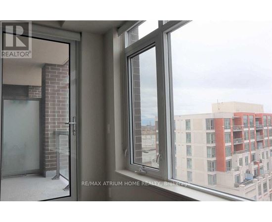 A view from a window of a building with a sign that says RE/MAX Atrium Home Realty.