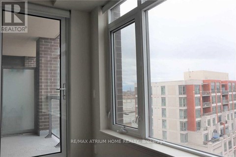 A view from a window of a building with a sign that says RE/MAX Atrium Home Realty.
