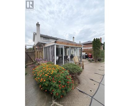 A house with a garden in front of it.
