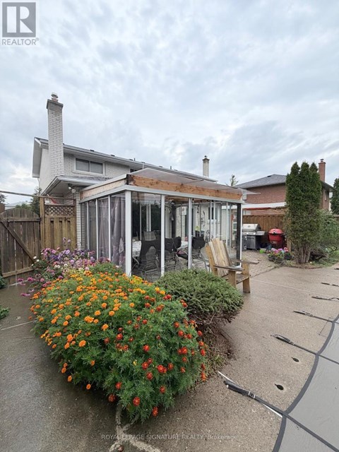 A house with a garden in front of it.