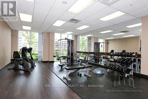 A gym with a variety of equipment including treadmills, weights and exercise machines.