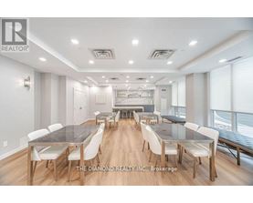 A dining room with a long table and chairs.