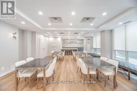 A dining room with a long table and chairs.