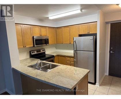 A kitchen with a sink, microwave, and refrigerator.
