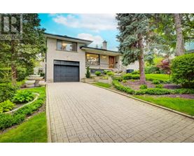 A house with a driveway and a garage is for sale.