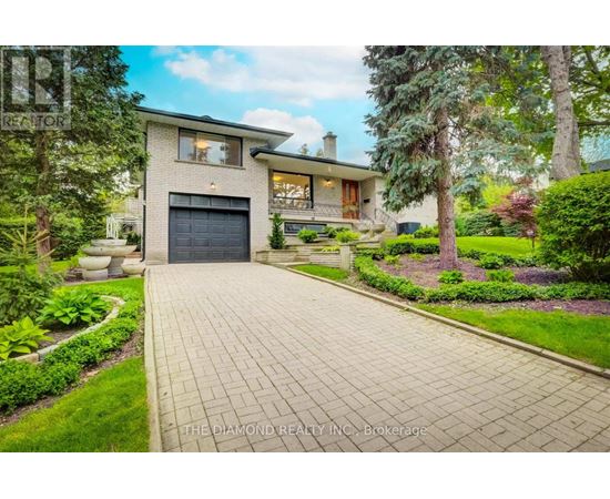 A house with a driveway and a garage is for sale.