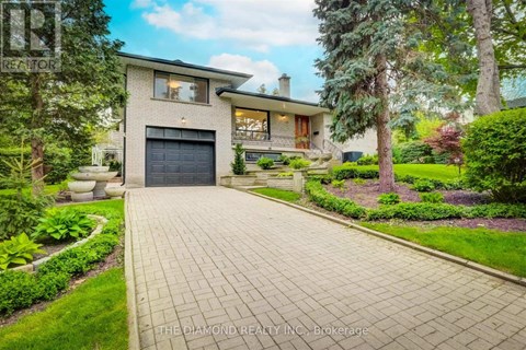 A house with a driveway and a garage is for sale.