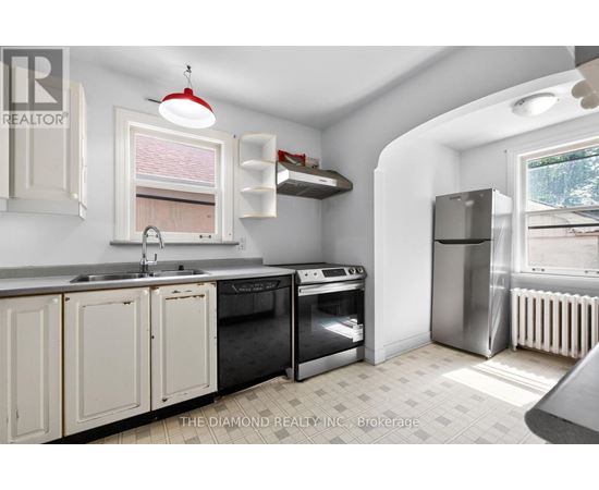 A kitchen with white cabinets and a black stove top oven.