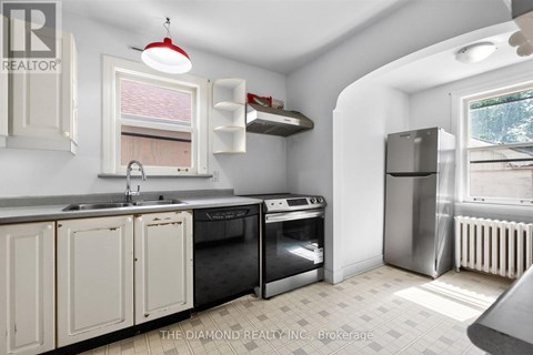 A kitchen with white cabinets and a black stove top oven.
