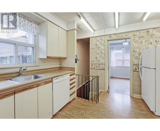 A kitchen with wooden cabinets and a white fridge.
