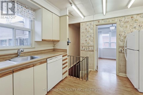 A kitchen with wooden cabinets and a white fridge.