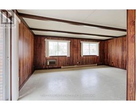 A room with wooden walls and a white ceiling.