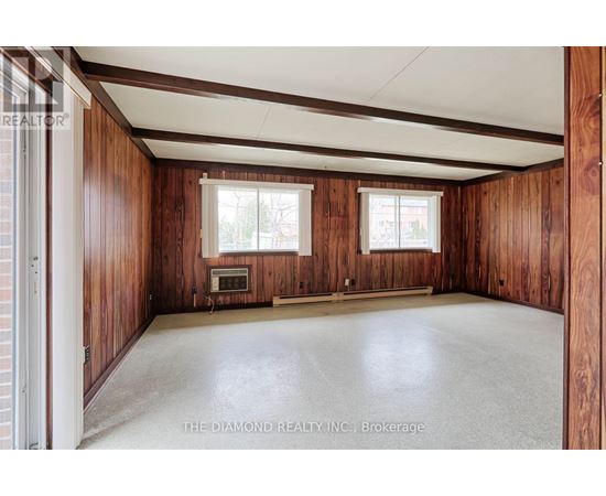 A room with wooden walls and a white ceiling.