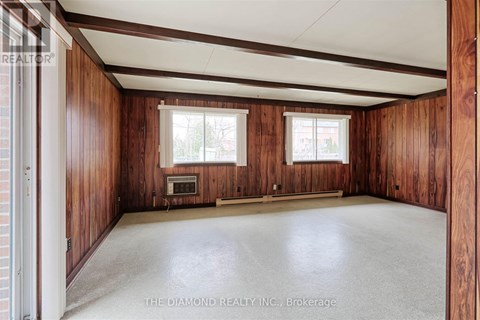 A room with wooden walls and a white ceiling.