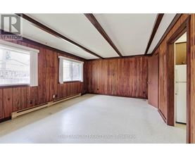 A room with wooden walls and a white ceiling.