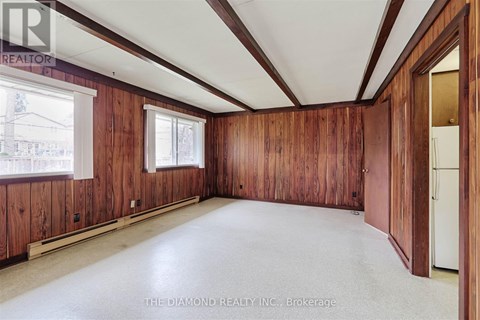 A room with wooden walls and a white ceiling.