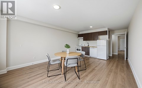 A dining room with a table and chairs is shown.