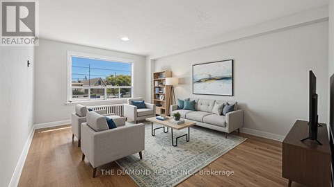 A living room with a couch, a chair, a coffee table, and a bookshelf.