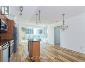 A kitchen with wooden floors and a large window.