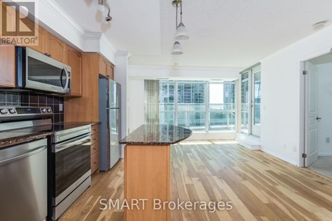 A kitchen with wooden cabinets and a black countertop.