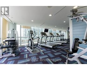 A gym with a variety of equipment including treadmills, stationary bikes, and weight machines.