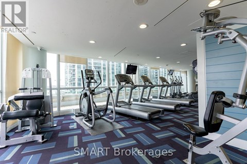 A gym with a variety of equipment including treadmills, stationary bikes, and weight machines.