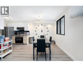 A kitchen with a dining table and chairs in the middle of the room.