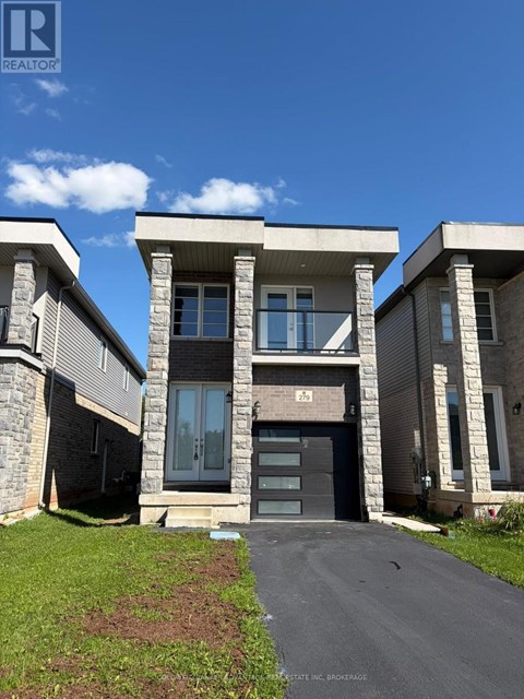 A modern house with a stone facade and a grey roof.