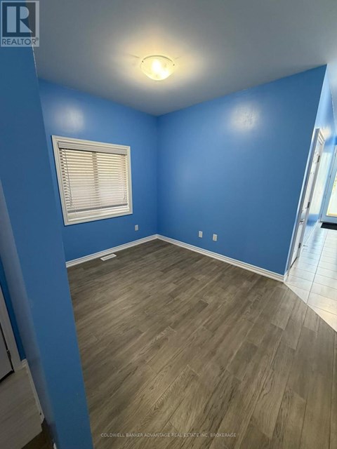 A room with blue walls and wooden flooring.