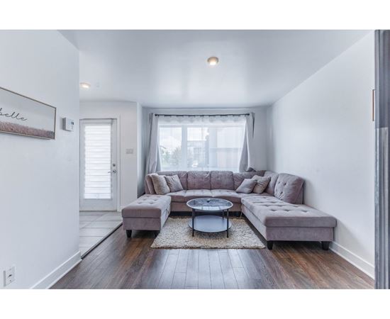 A living room with a grey couch and a coffee table.