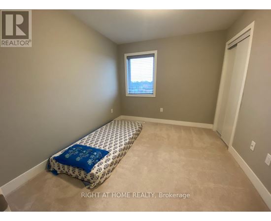 A bedroom with a bed and a window.