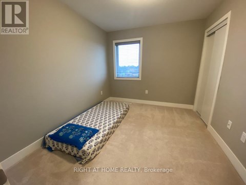 A bedroom with a bed and a window.