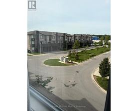 A view of a residential area with apartment buildings and a roundabout.