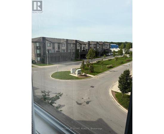 A view of a residential area with apartment buildings and a roundabout.