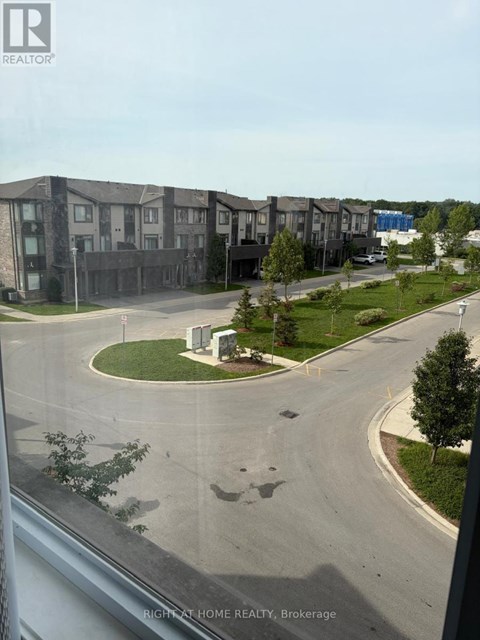 A view of a residential area with apartment buildings and a roundabout.