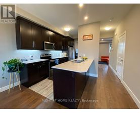 A kitchen with dark brown cabinets and a white countertop.