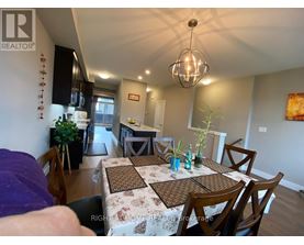 A dining room with a table set for four.