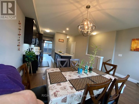 A dining room with a table set for four.