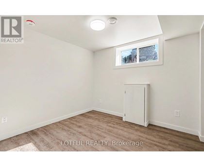 A room with a white cabinet and a window showing a snowy scene outside.