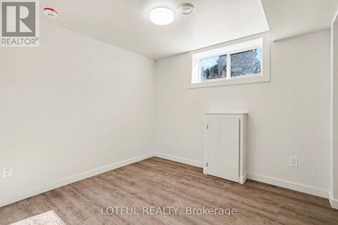 A room with a white cabinet and a window showing a snowy scene outside.
