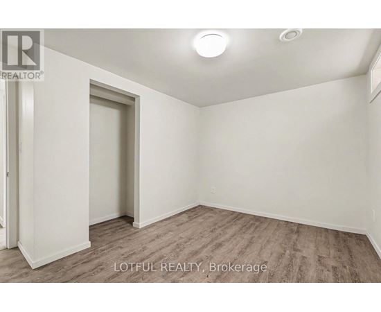 A room with a door and a window, with a wooden floor.