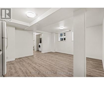 A spacious room with a washer and dryer in it.