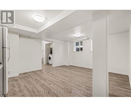 A spacious room with a washer and dryer in it.