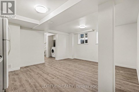 A spacious room with a washer and dryer in it.