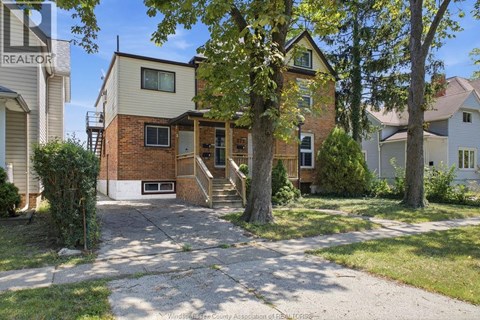 A house with a tree in front of it.