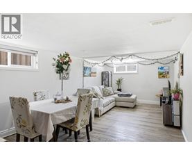 A dining room with a table set for four.
