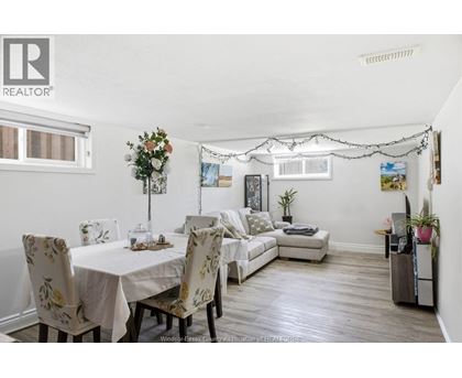 A dining room with a table set for four.